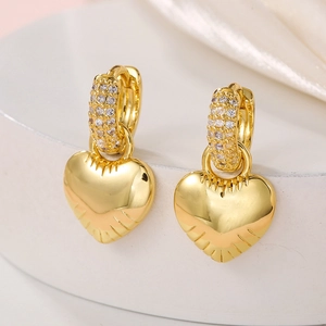 Detailed view of gold plated heart drop earrings with shimmering zircon micro-inlay