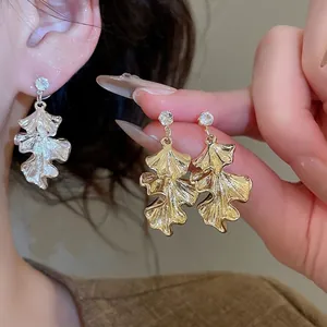 Elegant ginkgo leaf dangle earrings with sparkling zircon studs in gold and silver finish