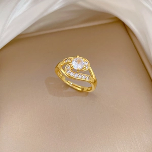 Luxurious gold ring with central round diamond and S-shaped paved zircon curves