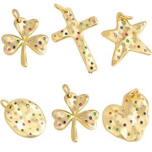 Detail of gold pendants with colorful zircons in clover, heart, and star shapes