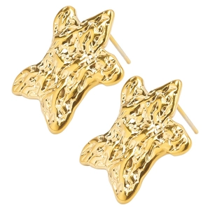 Detailed close-up of golden stainless steel star earrings with molten lava texture