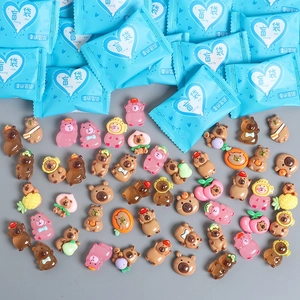 Close-up of cute cartoon resin animal figurines and lucky blind bag packaging
