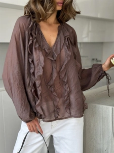 Detail of ruffle layers and V-neckline on a sheer coffee brown lantern sleeve blouse