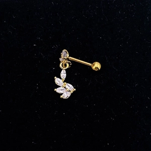 Close-up of golden leaf-shaped drop earrings with clear cubic zirconia on black velvet