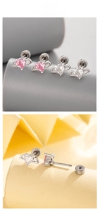 Macro view of heart-shaped angel wing ear studs with pink and white zircon details