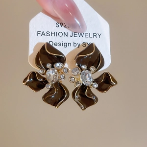Detail of S925 silver flower earrings with brown petals, gold edges and crystal inlay