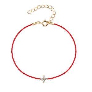 Close-up of S925 silver four-leaf clover zircon pendant on adjustable red cord bracelet