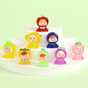 Close-up of assorted mini resin fruit figures in vibrant colors on a white display stand
