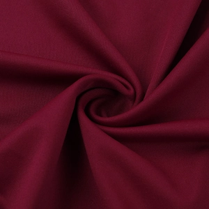 Detail of burgundy lace patchwork fabric showing soft texture and high elasticity