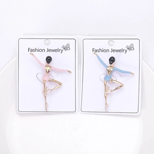 Macro detail of enamel ballet girl brooches in pink and blue on a display card