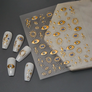 5D embossed gold nail art stickers featuring snake and evil eye patterns for luxury manicures