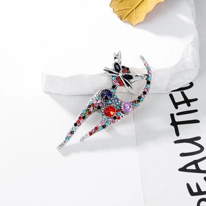 Macro detail of cat brooch with colorful rhinestones on a white marble base