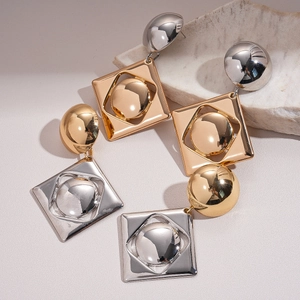 Geometric gold and silver mixed metal earrings in square and round shapes on stone
