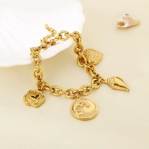 Detailed view of gold stainless steel bracelet with ocean shell and fishtail charms