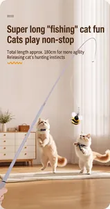 Action shot of long cat teaser wand with bee toy and kittens playing in cozy home