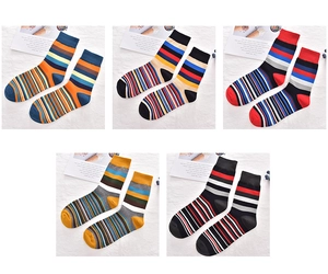 Flat lay of five pairs of men's colorful striped cotton crew socks on white background