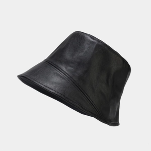 Close-up of black PU leather bucket hat showing fine texture and premium stitching detail