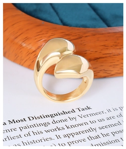 Detailed view of an 18K gold plated titanium ring with a unique organic streamlined design