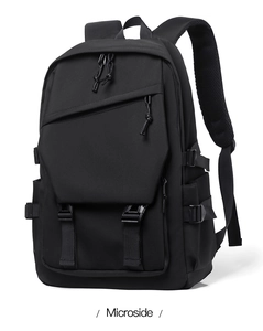 Detail view of thickened breathable shoulder straps and buckles on a black nylon backpack