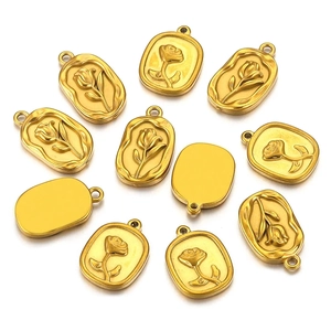 Detailed macro of 11 oval stainless steel rose pendants for DIY jewelry making in gold finish