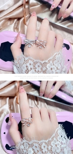 Close-up of sparkling bow knot rings in silver and rose gold with pavé crystals