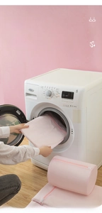 Pink fine mesh laundry bags for bras and clothes shown inside a washing machine