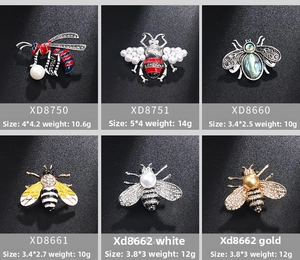 Detailed grid of six bee brooches with pearls and crystals on dark texture
