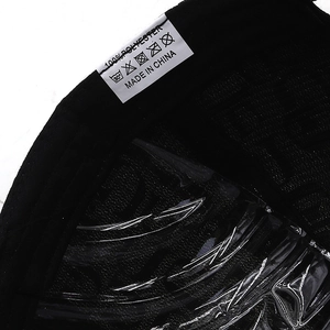 Detail showing the internal care label with 100% polyester material and washing symbols