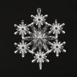 Macro shot of a transparent crystal snowflake ornament with a center hole for DIY crafts