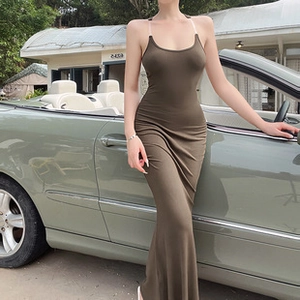 Detail of elegant olive green slim fit maxi dress with transparent straps and U-neckline