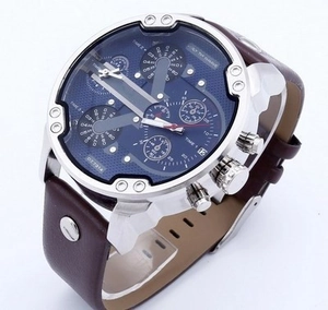 Detail view of the multi-timezone dial and brushed steel case on the oversized watch