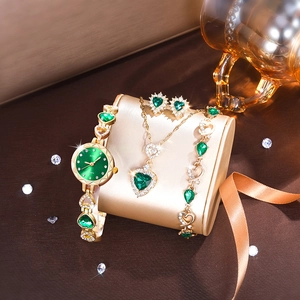 Luxury women's quartz watch set with green heart jewelry in a golden finish