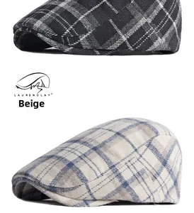 Detail shot of British plaid wool berets in classic grey and beige checkered patterns