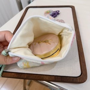 Detail showing internal capacity of the floral fabric pouch with zipper and soft cotton lining