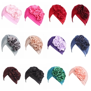 Detailed grid view showing 12 vibrant colors of stretchy turban hats with large flower decor
