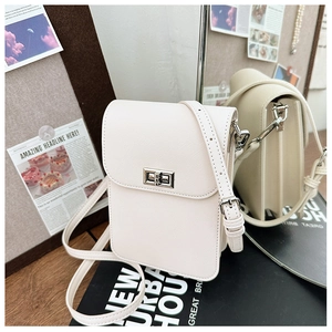 Detailed macro of cream white crossbody phone bag featuring refined crossgrain leather texture