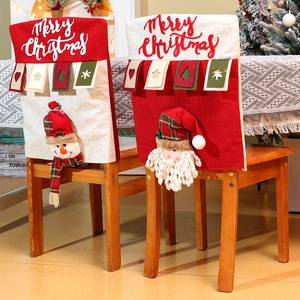 Detail of Christmas chair covers featuring Santa and Snowman with Merry Christmas embroidery