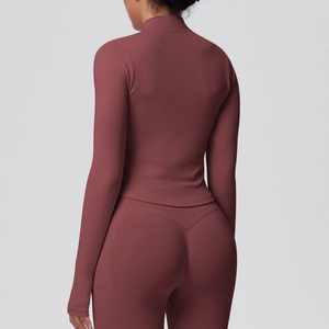 Close-up of the ribbed fabric and seamless fit on the back of this mauve yoga jacket