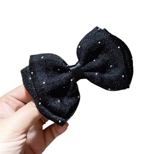 Elegant black fabric bow hair clip with sparkling silver beads on a clean white background