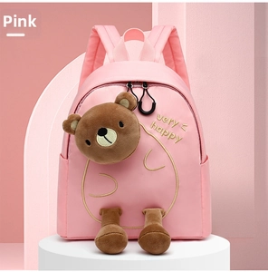 Detail of pink waterproof nylon kids backpack featuring cute 3D plush bear and embroidery