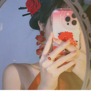 Chic red rose petal earrings and matching accessories shown in a mirror selfie display