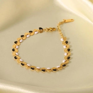 Elegant 18K gold plated heart bracelet with black and white enamel links on satin background