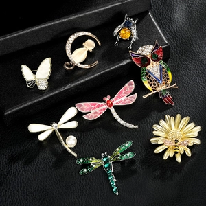 Collection of colorful alloy animal brooches with rhinestones and enamel on black leather