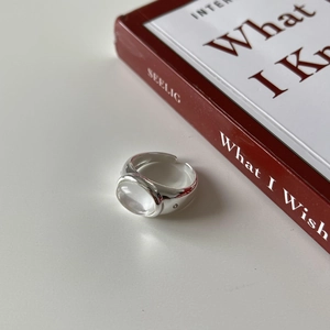 Minimalist S925 sterling silver ring with irregular zircon stone on white surface