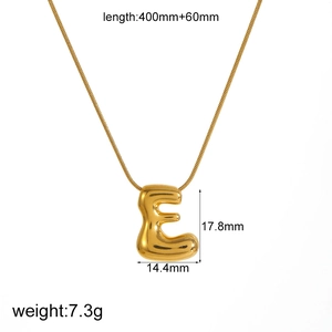 Macro detail of golden letter E pendant showing dimensions 17.8mm by 14.4mm on white background