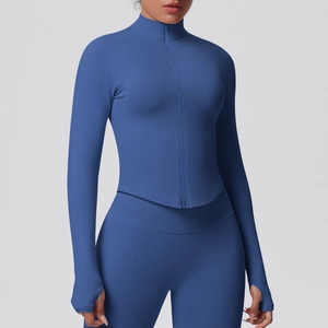 Close-up of ribbed knit texture and thumbhole cuff design on dark blue yoga top