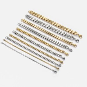 Cuban link chains in gold and silver tones with lobster clasps on white background
