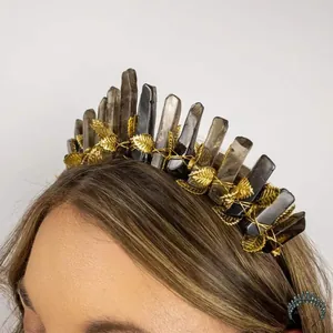 Macro detail of gold leaves and smoky crystal pillars on handmade tiara headband