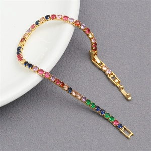 Macro shot of colorful zircon tennis bracelet with gold plating on white porcelain edge