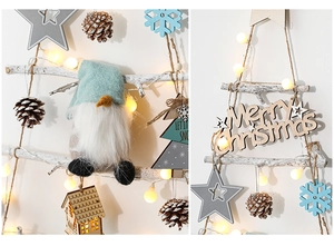 Close-up of wooden Christmas tree wall hanging with LED lights and felt ornaments